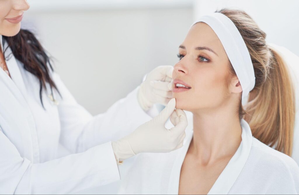 A female patient receiving a dermal fillers consultation from a medical professional in a clinic.