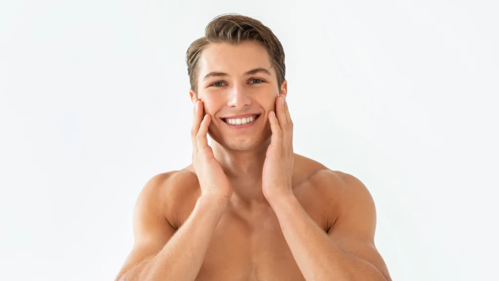 Smiling man with clear skin after undergoing pseudofolliculitis barbae treatments.